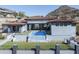 Beautiful home featuring a pool with a water feature, well manicured lawn, and mountain views at 6825 N 39Th Pl, Paradise Valley, AZ 85253