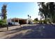 Covered carport offering parking for one car, adjacent to a gravel driveway with ample space for additional parking at 7043 E Ann Way, Scottsdale, AZ 85254