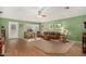 Bright living room with hardwood floors, wood furniture, and a ceiling fan at 7849 W Flynn Ln, Glendale, AZ 85303