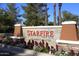 Starfire Golf Club sign featuring red lettering on a stone base with colorful flowers at 8055 E Cortez Dr, Scottsdale, AZ 85260