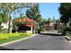 Gated entrance with a guard house, tile roof, and manicured landscaping at 8055 E Cortez Dr, Scottsdale, AZ 85260