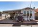 Mobile home exterior with covered carport and golf cart at 8700 E University Dr # 737, Mesa, AZ 85207