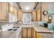 Bright kitchen featuring wood cabinets, built-in microwave, and electric range at 8700 E University Dr # 737, Mesa, AZ 85207