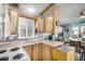 Kitchen with wood cabinets, stove, and sink at 8700 E University Dr # 737, Mesa, AZ 85207