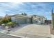 Single-story home with a two-car garage and desert landscaping at 8957 E Rainier Dr, Gold Canyon, AZ 85118