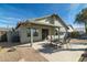Home exterior showcasing a covered patio and landscaped backyard at 8957 E Rainier Dr, Gold Canyon, AZ 85118