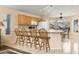 Kitchen with island seating, wood cabinets, and view to the backyard at 8957 E Rainier Dr, Gold Canyon, AZ 85118