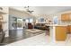 Open living space with hardwood floors, patio access, and a kitchen island at 8957 E Rainier Dr, Gold Canyon, AZ 85118