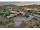 Sprawling estate featuring a circular driveway, well-manicured landscaping, and a private backyard pool at 9815 N Copper Ridge Trl, Fountain Hills, AZ 85268