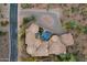 Bird's eye view of a desert estate showcasing its unique architecture, pool, patio and driveway layout at 9815 N Copper Ridge Trl, Fountain Hills, AZ 85268