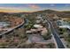 Breathtaking aerial view of desert homes near a golf course with distant mountains and colorful evening skies at 9815 N Copper Ridge Trl, Fountain Hills, AZ 85268