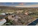 Drone shot of a desert neighborhood with a golf course and mountain views at sunset at 9815 N Copper Ridge Trl, Fountain Hills, AZ 85268