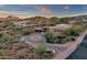 View of desert home featuring desert landscaping, circular driveway and mountain views at 9815 N Copper Ridge Trl, Fountain Hills, AZ 85268