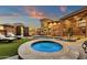 Inviting backyard with a spa, lounge chairs, outdoor kitchen, and access to the main house at 9815 N Copper Ridge Trl, Fountain Hills, AZ 85268