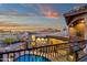 View from balcony of backyard with blue pool, pavers, and desert landscaping at sunset at 9815 N Copper Ridge Trl, Fountain Hills, AZ 85268