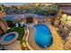 Aerial shot of backyard with pool, spa, built-in grill, and desert landscaping at 9815 N Copper Ridge Trl, Fountain Hills, AZ 85268