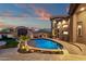Backyard features a pool, built-in grill, desert landscaping, and views of distant mountains at 9815 N Copper Ridge Trl, Fountain Hills, AZ 85268