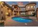 Spacious backyard with a freeform pool, outdoor seating, and elegant architectural details at 9815 N Copper Ridge Trl, Fountain Hills, AZ 85268