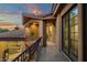 View of covered balcony with iron railing featuring tan stucco walls and sunset sky views at 9815 N Copper Ridge Trl, Fountain Hills, AZ 85268