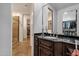 Bathroom with a dark vanity with a mirror and a tiled shower with glass doors at 9815 N Copper Ridge Trl, Fountain Hills, AZ 85268