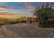 Beautiful home with a circular driveway, three-car garage, stone accents, and desert landscaping at 9815 N Copper Ridge Trl, Fountain Hills, AZ 85268