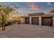 Spacious three-car garage with stone accents and wooden doors at 9815 N Copper Ridge Trl, Fountain Hills, AZ 85268
