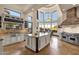 Gourmet kitchen featuring a center island, custom cabinetry, modern appliances and stone hood at 9815 N Copper Ridge Trl, Fountain Hills, AZ 85268