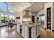 Gourmet kitchen showcasing a large island, stone range hood, and stainless steel appliances at 9815 N Copper Ridge Trl, Fountain Hills, AZ 85268