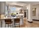 Chef's kitchen featuring an island, bar seating, high-end appliances, and stone accents at 9815 N Copper Ridge Trl, Fountain Hills, AZ 85268