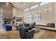 Inviting living room with stone fireplace, comfortable seating, and tall windows providing natural light at 9815 N Copper Ridge Trl, Fountain Hills, AZ 85268