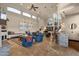 Open-concept living room with large windows, stone accents, and a view of the staircase and kitchen at 9815 N Copper Ridge Trl, Fountain Hills, AZ 85268