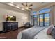 Spacious main bedroom with a dresser, chair, dark floors, and french doors to the outside at 9815 N Copper Ridge Trl, Fountain Hills, AZ 85268