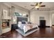 Luxurious main bedroom with a fireplace, plush bedding, and dark wood floors at 9815 N Copper Ridge Trl, Fountain Hills, AZ 85268