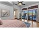 Bright main bedroom featuring tile floors, ceiling fan and access to the outdoor living area at 9815 N Copper Ridge Trl, Fountain Hills, AZ 85268