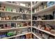 Spacious walk-in pantry with ample shelving, stocked with various food items and household goods at 9815 N Copper Ridge Trl, Fountain Hills, AZ 85268