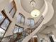 Elegant staircase with wrought iron railing under large windows and a decorative light fixture at 9815 N Copper Ridge Trl, Fountain Hills, AZ 85268