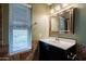 Clean bathroom with dark vanity and updated fixtures at 10445 N 11Th Pl # 1, Phoenix, AZ 85020