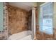 Clean bathroom with tile shower/tub combo and window at 10445 N 11Th Pl # 1, Phoenix, AZ 85020