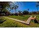 Green lawn with palm trees and a wood bench, providing a relaxing outdoor area at 10445 N 11Th Pl # 1, Phoenix, AZ 85020