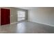 Open living area with tiled floors and red front door at 10445 N 11Th Pl # 1, Phoenix, AZ 85020