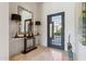 Bright entryway with a modern console table and large mirror at 10585 E Crescent Moon Dr # 33, Scottsdale, AZ 85262