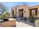 Stunning desert home exterior with inviting courtyard entry and beautiful landscaping at 10585 E Crescent Moon Dr # 33, Scottsdale, AZ 85262