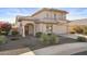 Two-story house with a tan stucco exterior, tile roof, and landscaped yard at 10765 N 119Th St, Scottsdale, AZ 85259