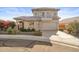 Two-story house with a tan stucco exterior, tile roof, and landscaped yard at 10765 N 119Th St, Scottsdale, AZ 85259