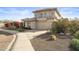 Two-story house with a tan stucco exterior, tile roof, and landscaped yard at 10765 N 119Th St, Scottsdale, AZ 85259