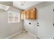 Bright laundry room with wood cabinets and tile floor at 10765 N 119Th St, Scottsdale, AZ 85259