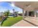 Covered patio with ceiling fan, adjacent to pool and lawn at 10765 N 119Th St, Scottsdale, AZ 85259