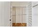 Large walk-in closet with shelving and hanging rods at 10765 N 119Th St, Scottsdale, AZ 85259