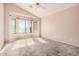 Bedroom with bay window, carpet, and ceiling fan at 1085 W Dava Dr, Tempe, AZ 85283