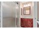 Bathroom with wood vanity and shower stall at 11029 W Meade Dr, Sun City, AZ 85351